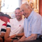 Bilde av avdøde Kong Harald V sammen med spiller e på landslaget i fotball sommeren 2026, inne på Slottet i Oslo